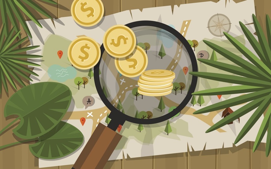 Magnifying glass over treasure map with coins spread about.
