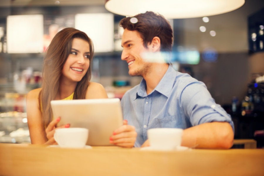 Couple Using Tablet at Cafe