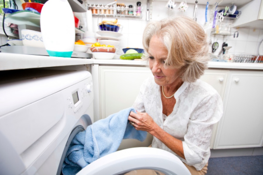 Senior Woman Loading Washing Machine