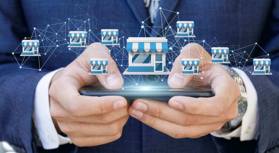 Businessman showing off franchise network on mobile device.