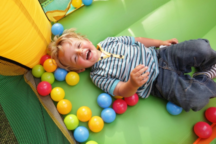 Boy Playing in Inflatable Bounce House
