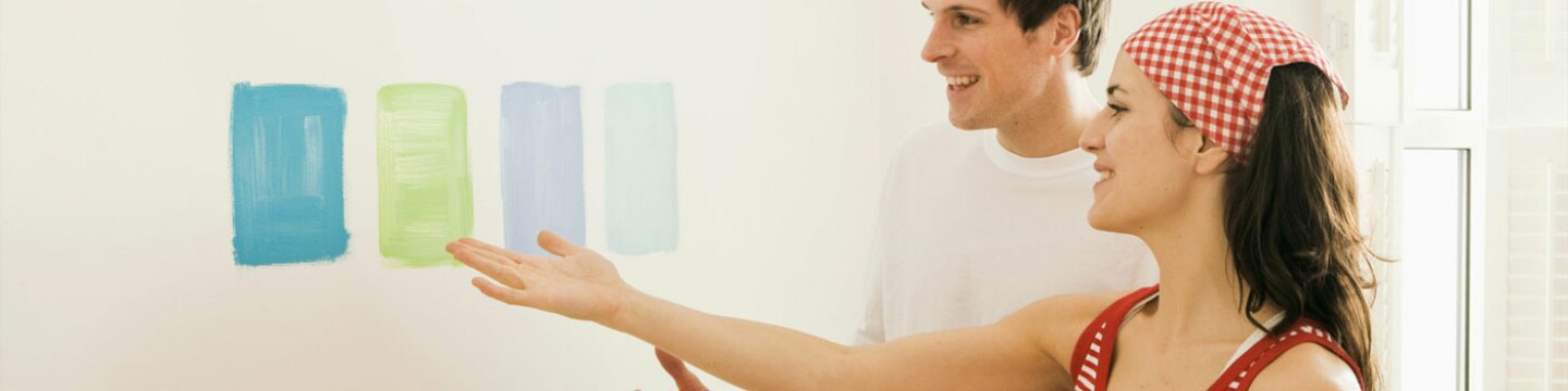 A couple choosing colours to decorate their walls