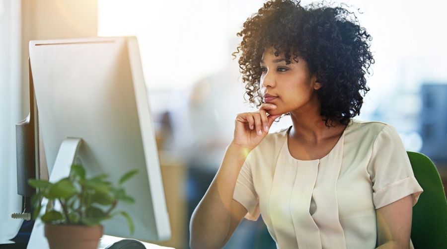 Young female designer working at her computer in an office.