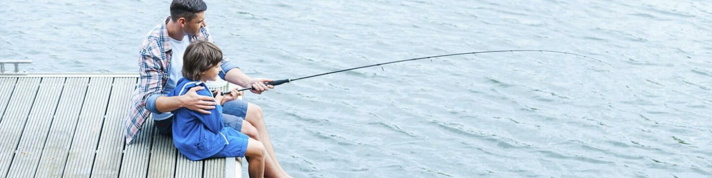 Father and son fishing from a pier