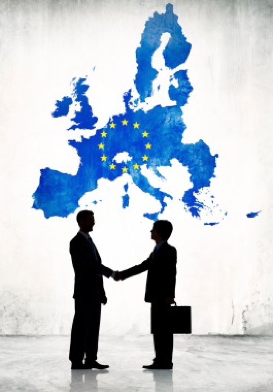 Two Businessman Shaking Hands With EU Cartograph Background