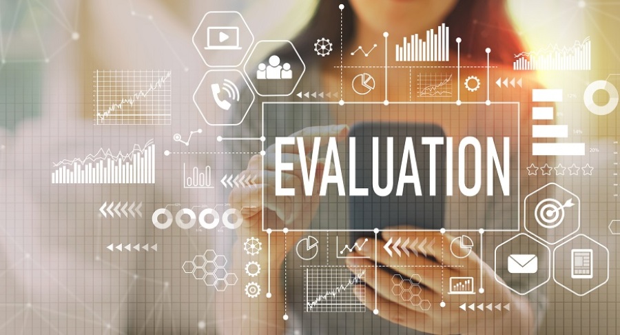 Graphic with the word "Evaluation" surrounded by various graphs with a woman using her smartphone in the background.