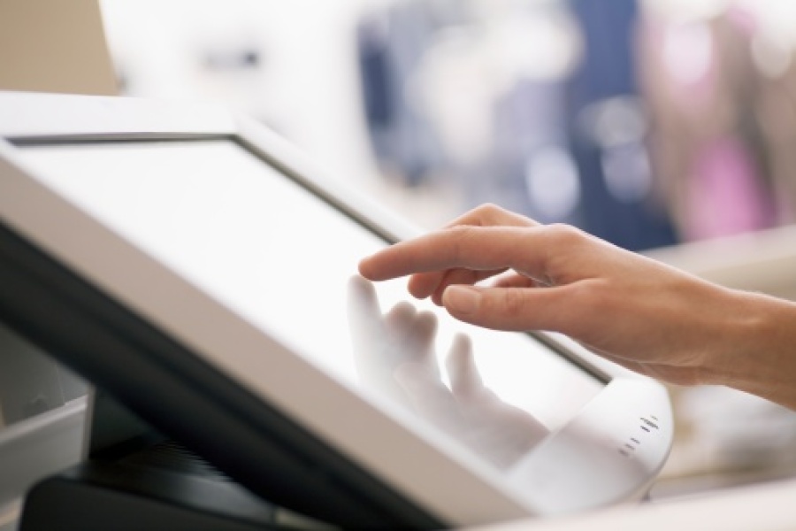 Lady Using a Touchscreen Till