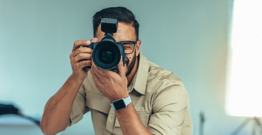 Straight on shot of male photographer readying to take a photo.