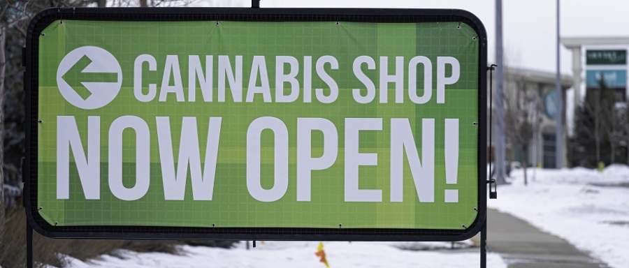 Sign saying "Cannsbis Shop Now Open!"