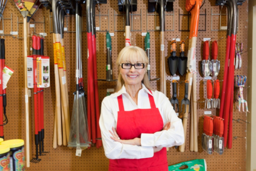 Woman Standing in Front of Garden Tools in Store