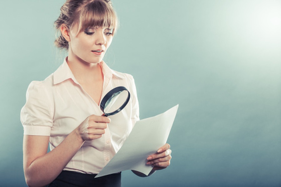 Woman Examining with Magnifying Glass