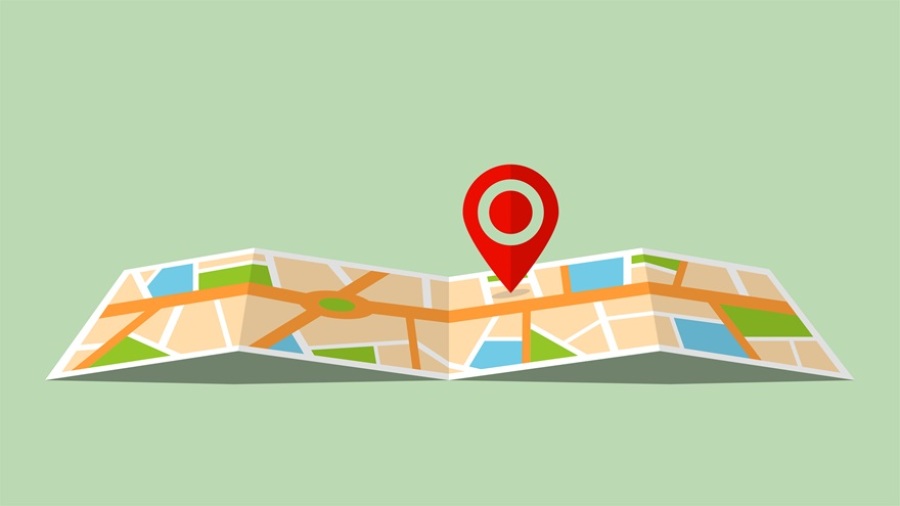 Illustration of a map on a light green background with a red location pin hovering over it.