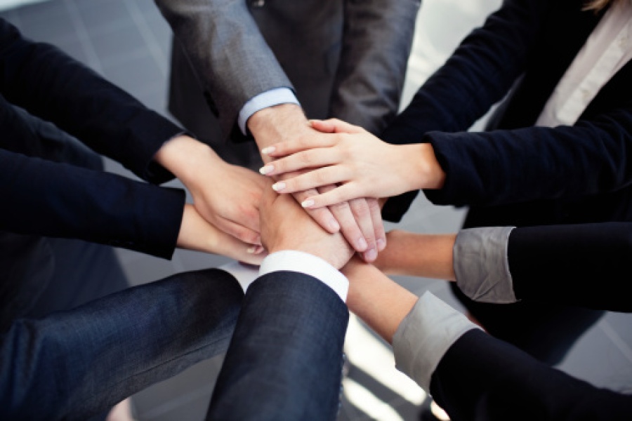 Business People Joining Hands in Collaboration