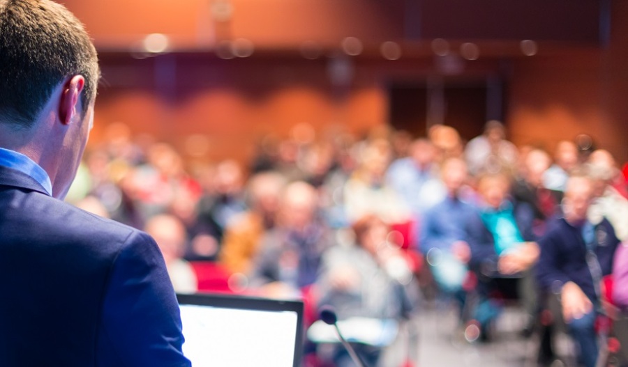 Speaker giving presentation at business conference.